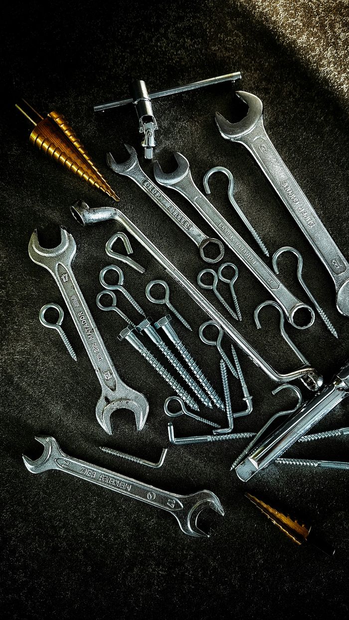 Services Rustic assortment of metal wrenches, screws, and drill bits, perfect for workshops or mechanical projects.