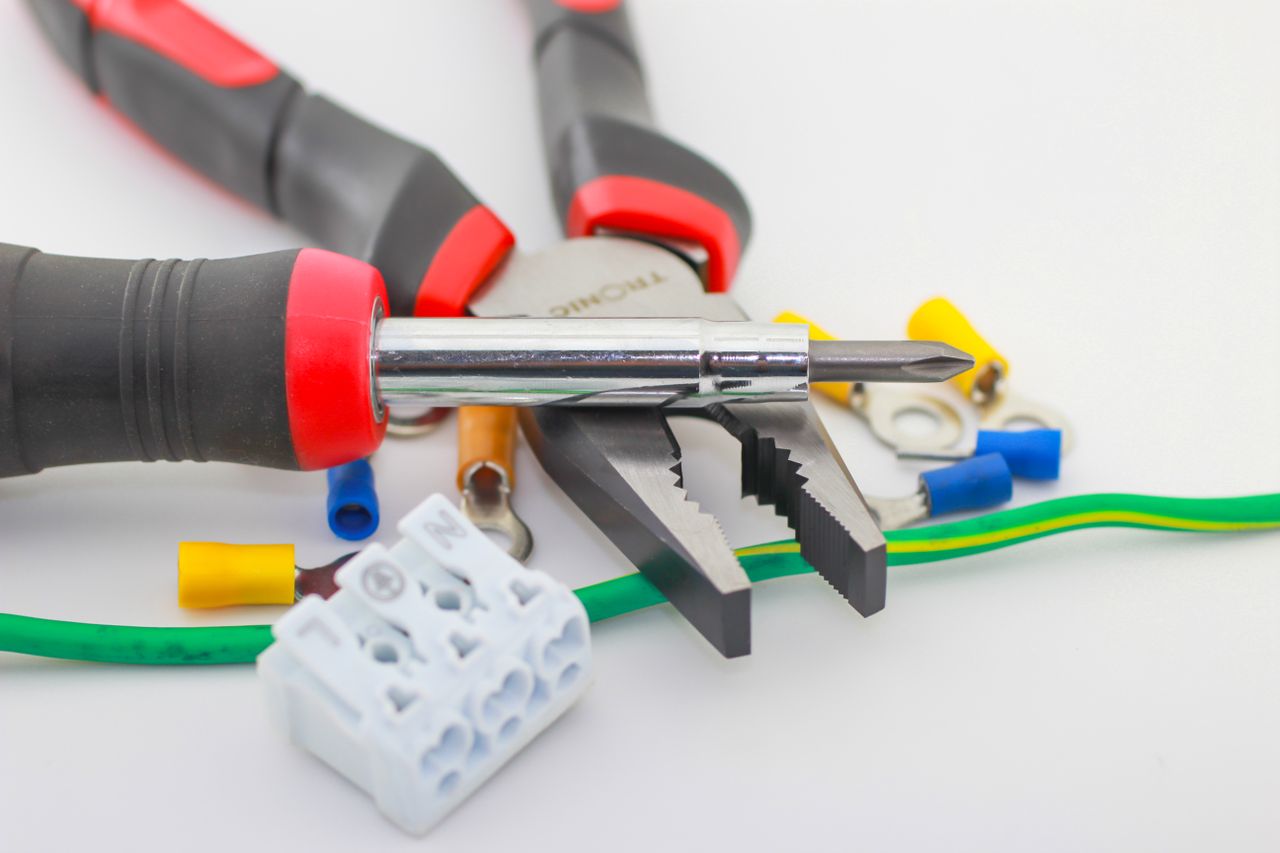 Crafting Captivating Headlines: Your awesome post title goes here A detailed close-up of hand tools including a screwdriver and pliers with various wiring accessories.